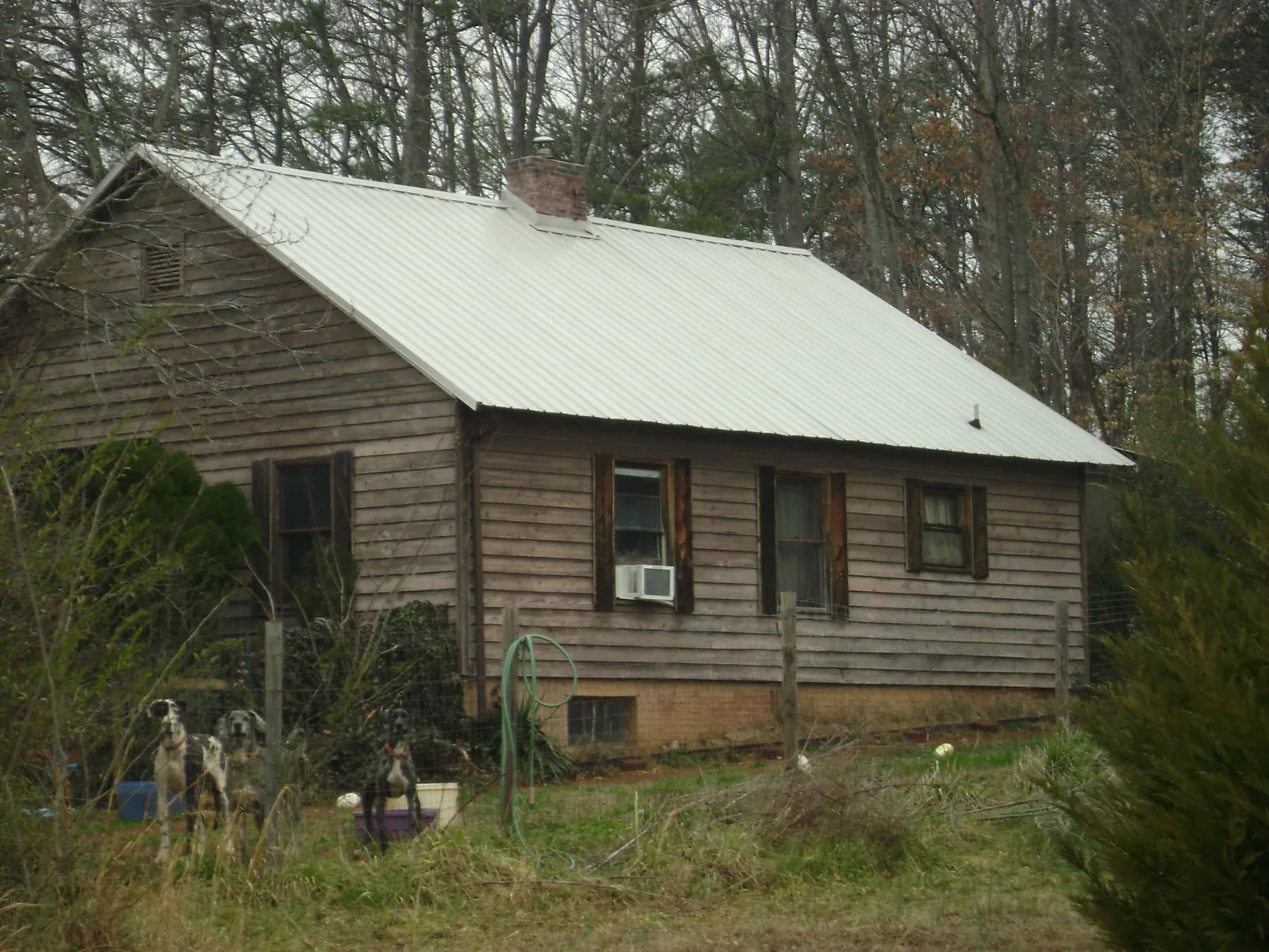 White metal roof on an old wood sided farmhouse, from a Metal Roof Installation job in Taylorville
